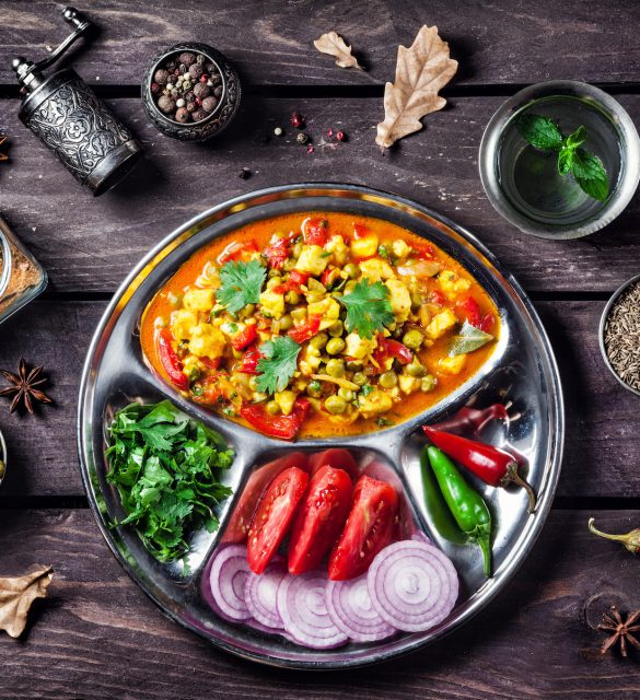 Mutter paneer in India Indian Mutter paneer dish with spices on the wooden background