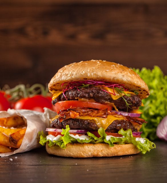 Delicious hamburger served on wooden planks