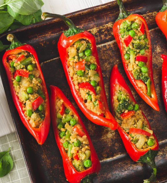 Cooking Vegan stuffed pepper with soy meat and vegetables on the table