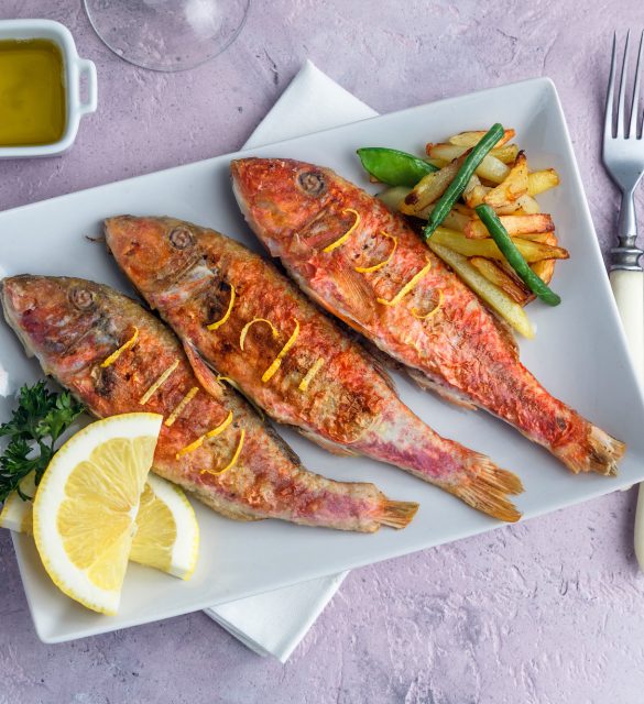 Fried Red Mullet or Turkish Barbunya on Plate, top view.
