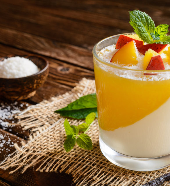 Coconut panna cotta dessert with mango jelly in a glass jar